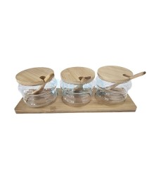 Wooden stand with three jars and a spice spoon